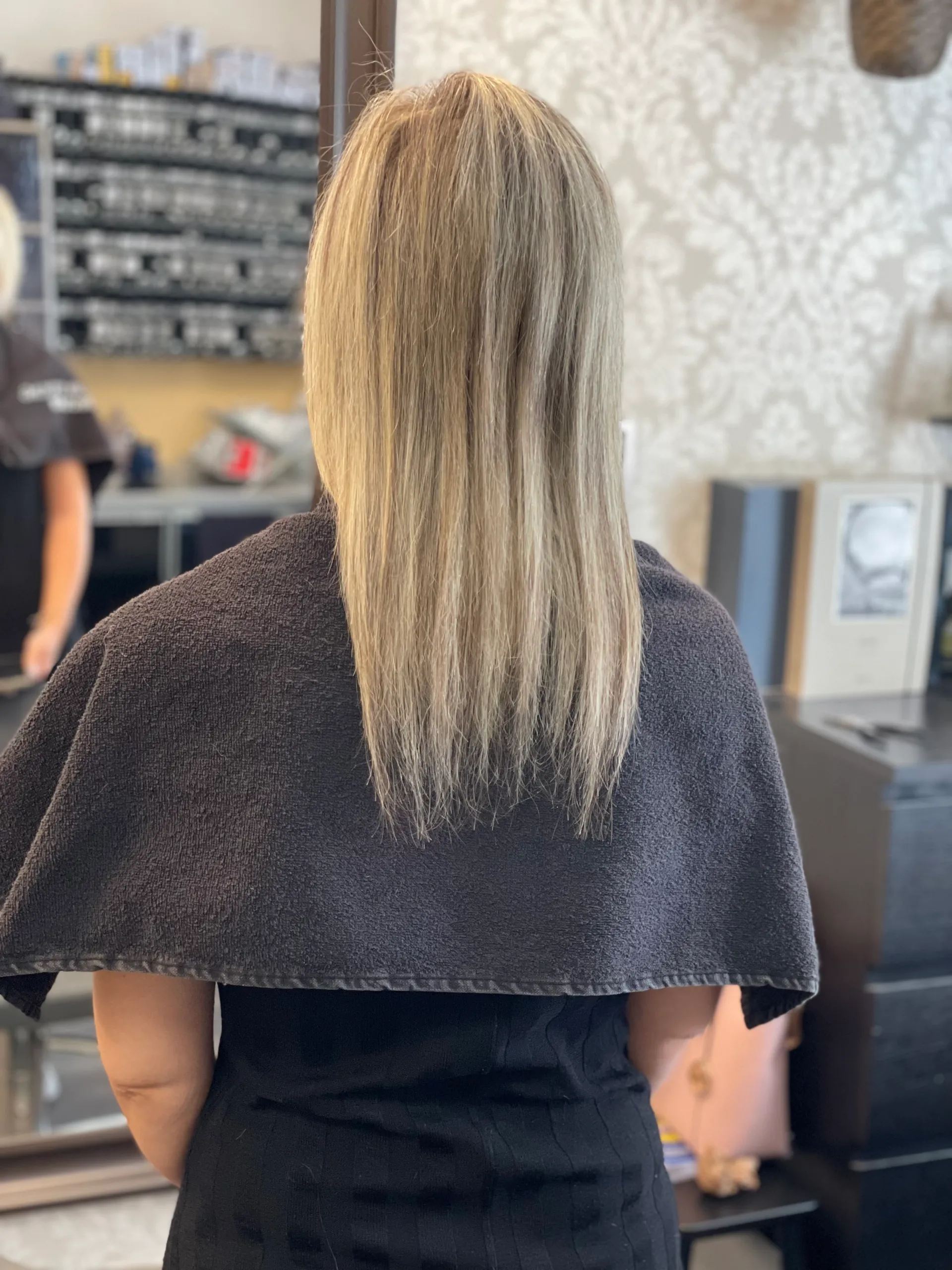 Blonde hair with visible dark roots needing color refresh